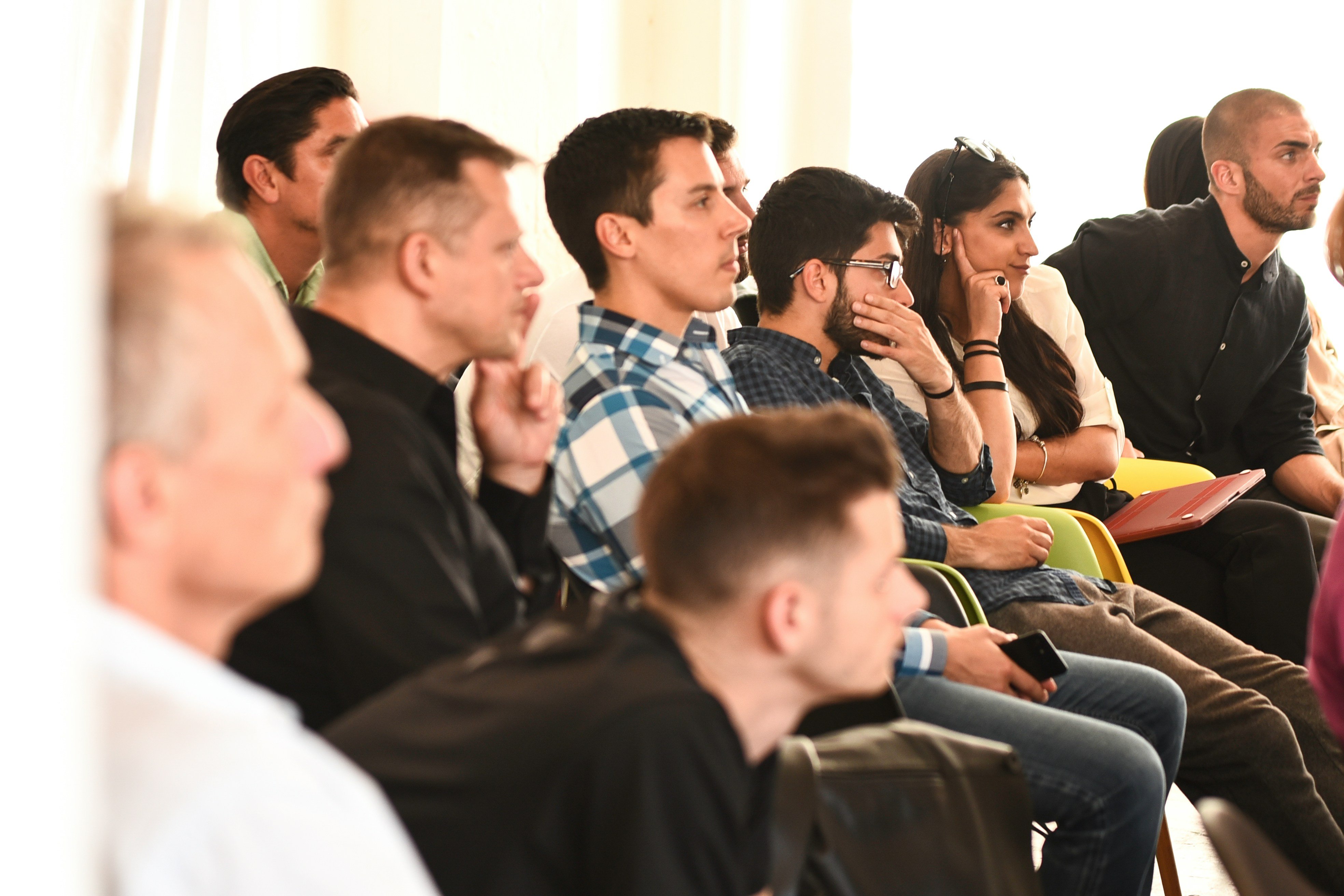 Audience members listening at a public event