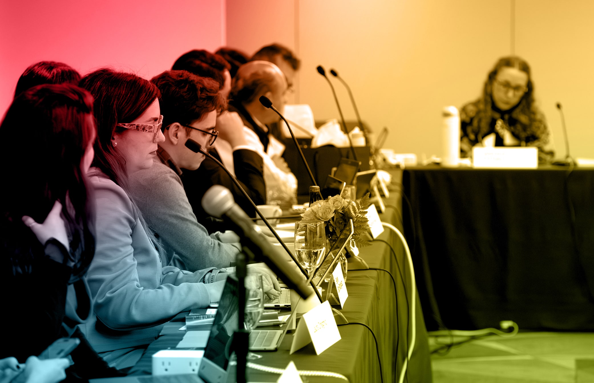 Speakers at a panel discussion during a conference